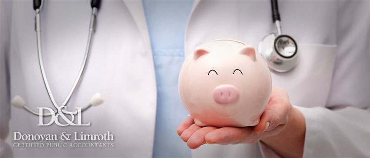 Doctor holding piggy bank